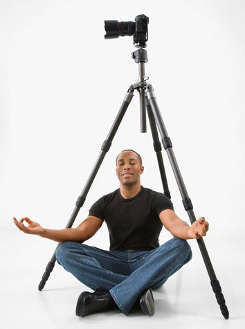 Photographer meditating under camera.